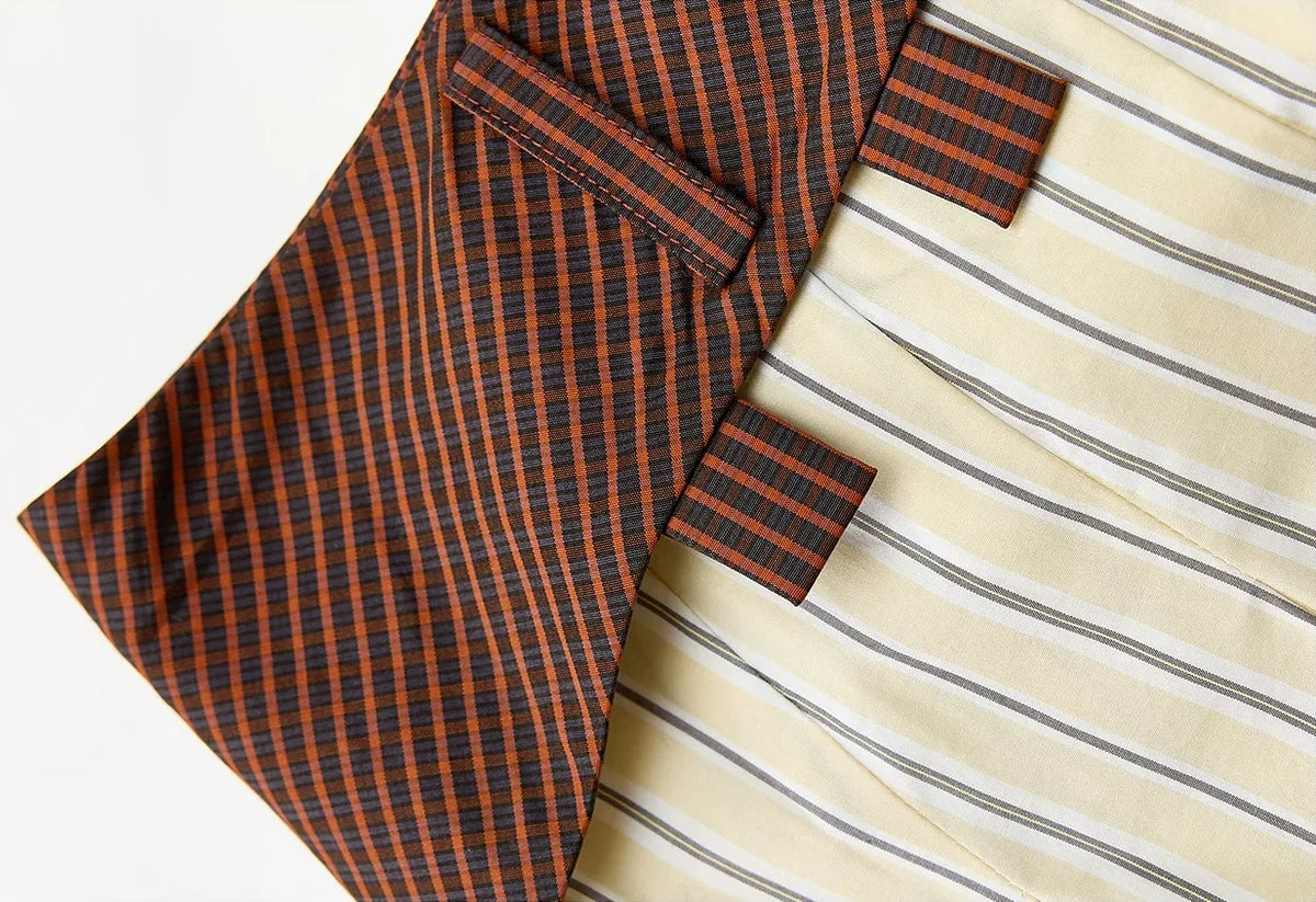 Mixed-Check Pleated Midi Skirt - contrasting fabric panel detail